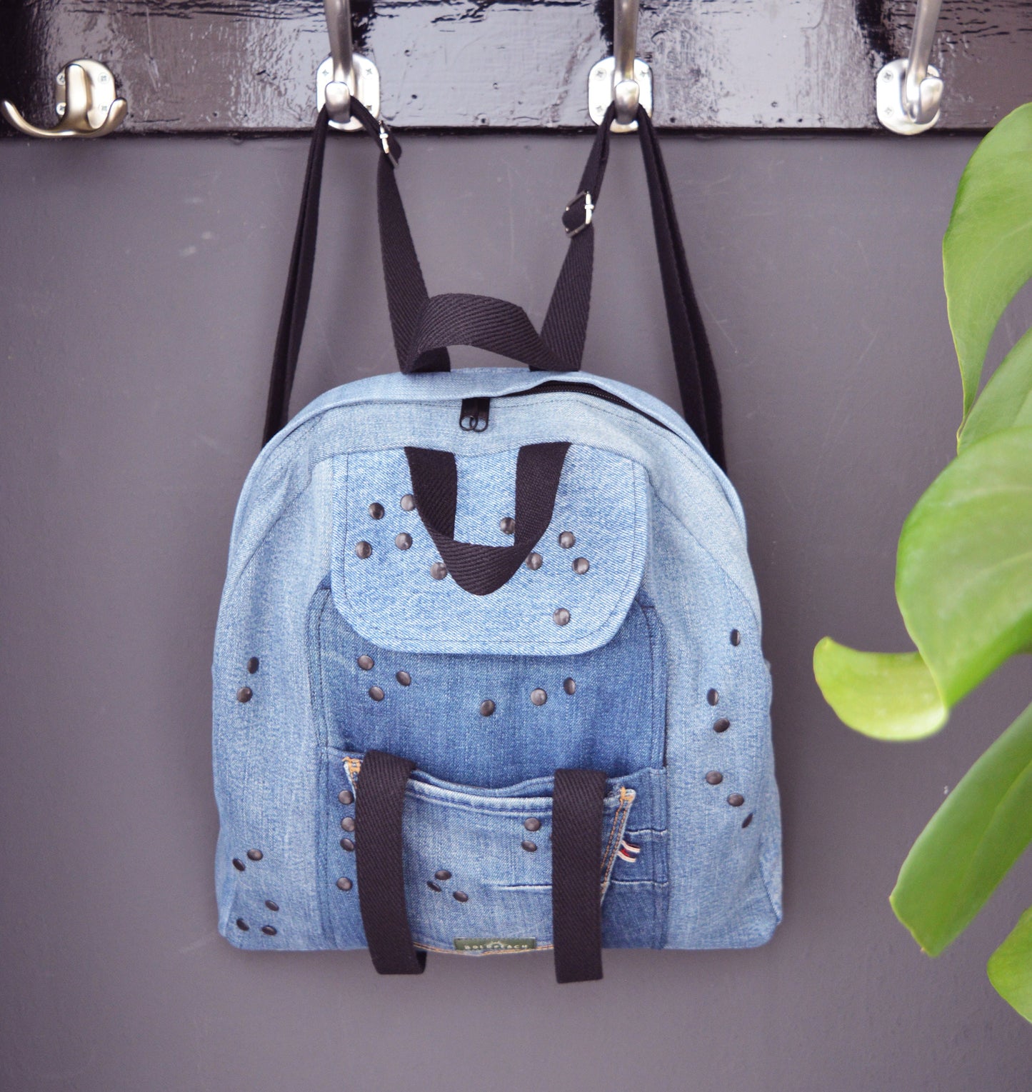 Denim backpack with black studs and lots of pockets