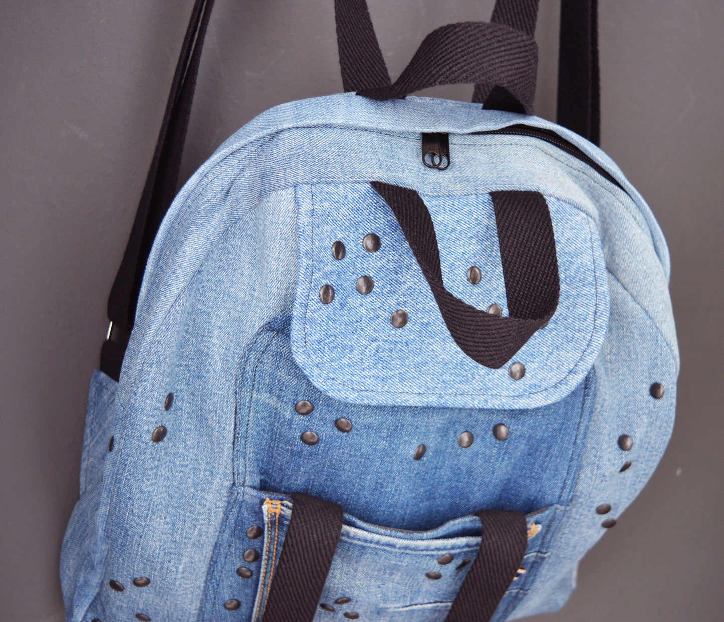 Denim backpack with black studs and lots of pockets